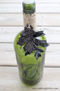 See how to make this quick and easy wine bottle candle holder! Perfect home decor and entertaining idea for Fall tablescapes, holiday tables, weddings and outdoor living areas. 