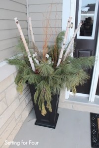 Urn decor with curly willow, fresh pine, birch branches and large pinecones