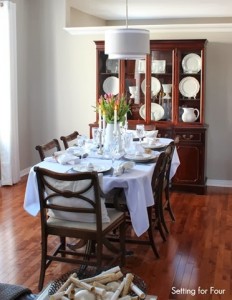 Dining Room decorated for spring with tulips, white dishes and crystal Dining Room decorated for spring with tulips, white dishes and crystal
