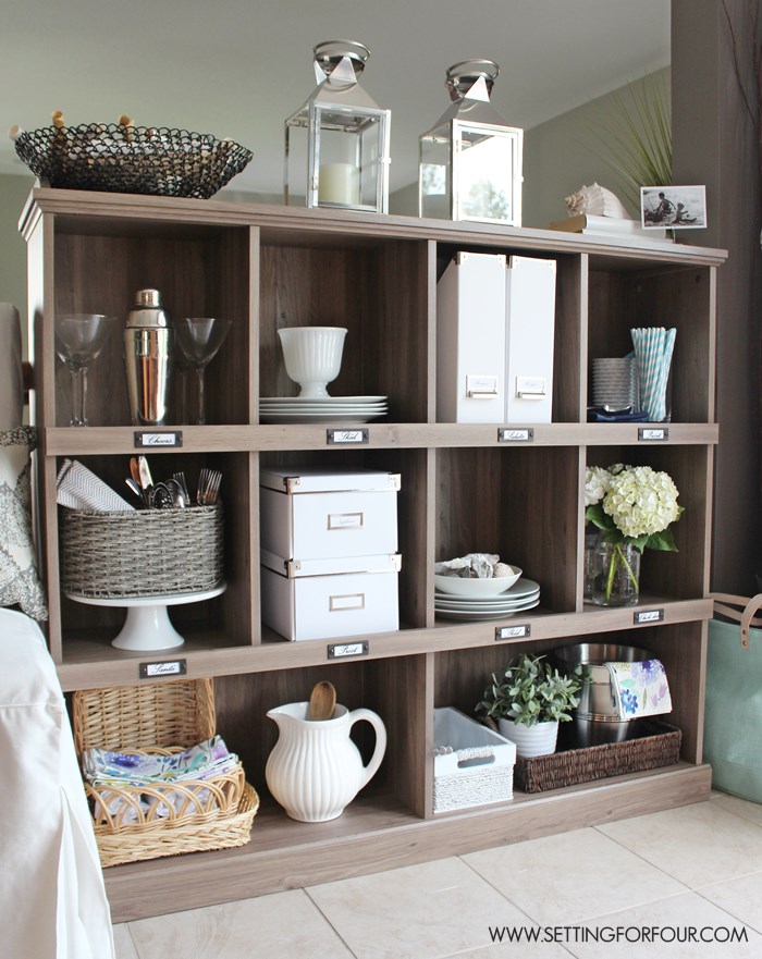 Add storage and organization to your kitchen with a bookcase! See how I organized my entertaining supplies with this gorgeous driftwood finish bookcase! www.settingforfour.com