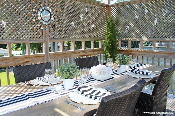 See how to create a beautiful black and white tablescape - al fresco style! - using stylish awning stripe table linens plus simple centerpiece ideas.