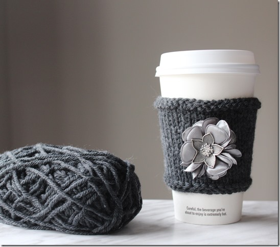 Learn how to make this QUICK AND EASY DIY Cashmere Cup Cozy! I added a pretty fabric flower accent to it. See the knitting tutorial and supply list to make this fun mug cozy craft. Great gift idea!