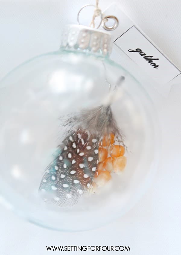 Make these easy DIY Feather Ornaments filled with corn kernels and other filler ideas for your fall and holiday tables or Christmas tree decor! Makes a great gift idea and present topper too!