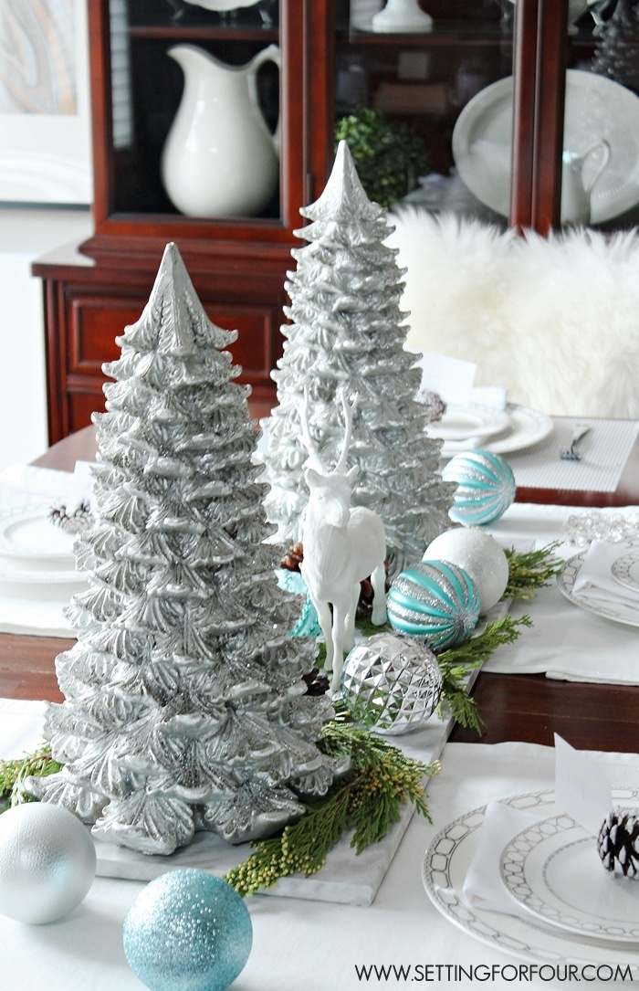 Festive Christmas centerpieces arrangement with candles, ornaments, and greenery