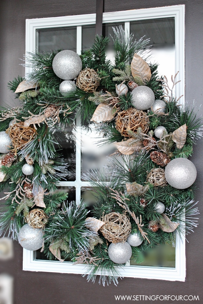 See my Christmas Entryway Decor with Winter Woodland Glam style! Front door wreath and garland decor, urns filled with greenery and birch. www.settingforfour.com