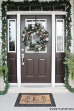 See my Christmas Entryway Decor with Winter Woodland Glam style! Front door wreath and garland decor, urns filled with greenery and birch. www.settingforfour.com
