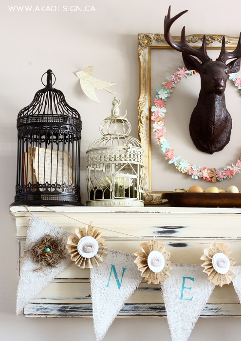 Spring Mantel with DIY floral paper wreath, burlap banner and bird cages.