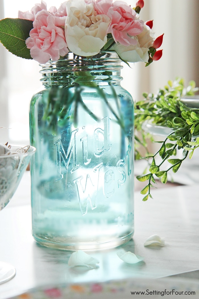 Such a clever DIY tip! This is the quickest, easiest way (ever!) to tint mason jars blue - no messy painting required! I can't believe how quick it is to get that perfect vintage blue mason jar color! www.settingforfour.com