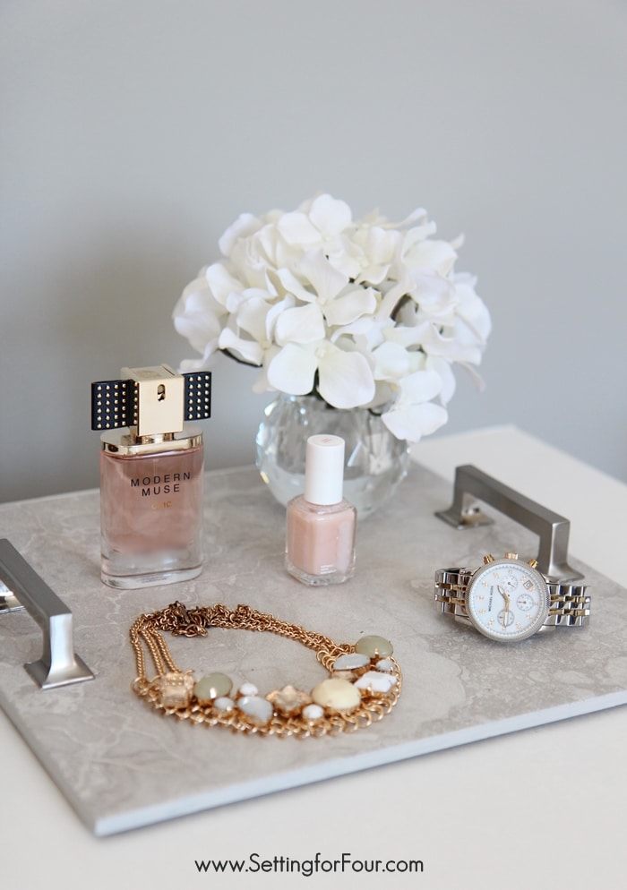 Learn how to make this beautiful tray with this easy DIY tray tutorial using tile and cabinet handles - what a great way to use leftover tile from a kitchen or bath renovation - or create a tray using pretty Carrara marble tile! This is a quick and easy, inexpensive tray to make that's perfect to organize your perfume and jewelry in your bedroom/bathroom, display books and decor on a coffee table, centerpiece idea for your dining table or as a food and drink serving tray when you're entertaining. Such a gorgeous wedding, anniversary, hostess or holiday gift idea too!