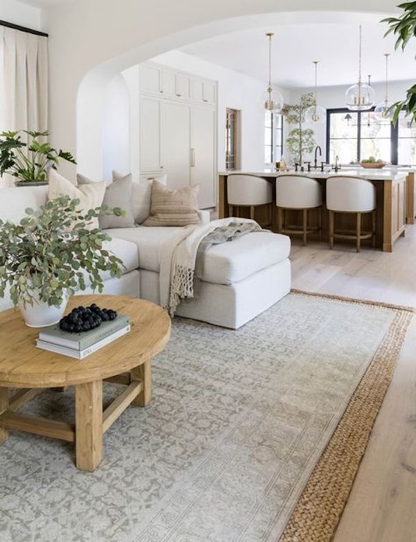 How To Layer Area Rugs Living Room Decor Ideas. modern organic, transitional, large area rug, open concept living room and kitchen, neutral, natural, wood and white, neutral color scheme, whole house color palette ideas, home decor ideas