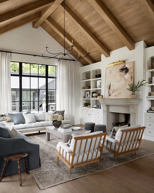 Cozy Neutral Living Room Decor and Furniture Layout Ideas. great room decor ideas, furniture arrangement, bookshelf builtin ideas, wood ceiling, wood beams, large area rug, sofa, 2 chairs, fireplace decor, modern, transitional, farmhouse, classic