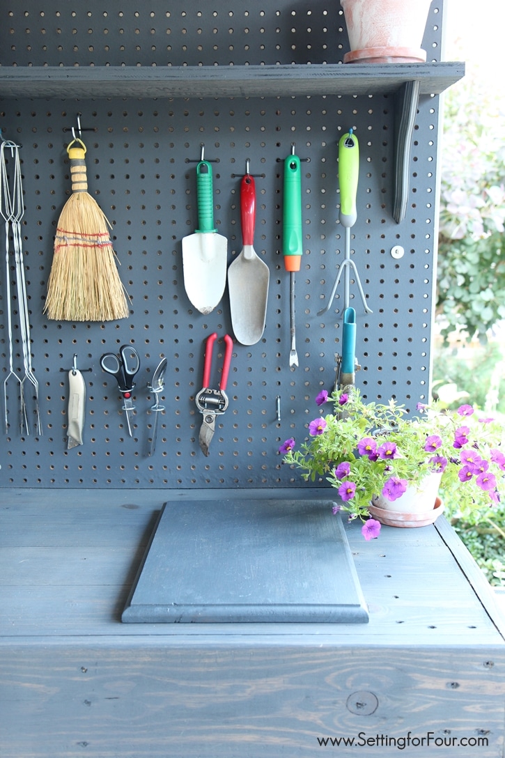 If you love to garden you'll want to make this!! DIY Pallet Wood Potting bench with tons of amazing features - like pegboard and hooks for organizing and storing lots of gardening tools! Instructions and supply list to make it included at www.settingforfour.com