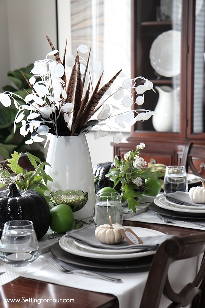 Take a nature walk outside and gather some wildflowers, branches and leaves for an easy fall tablescape! These fall wildflower tabletop decorating ideas will give your basic white dishes a show stopping look for Autumn. Adding these charming pumpkin place cards to each place setting also adds festive fall style to your table. See how you can create this look!