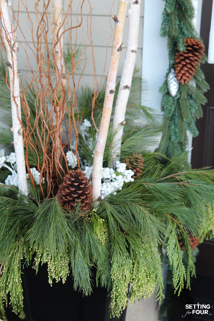 Come see all of my Holiday Cheer Outdoor Christmas Decorations and Christmas Entryway Home Tour. Adding planters filled with birch, curly willow and fresh pine is a great way to add curb appeal! www.settingforfour.com