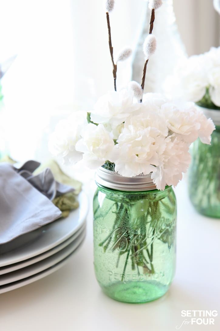 Learn how to make this 10 Minute DIY Floral Mason Jar Idea with pussy willows and carnations: See my budget saving secret to making these gorgeous centerpiece decorations!