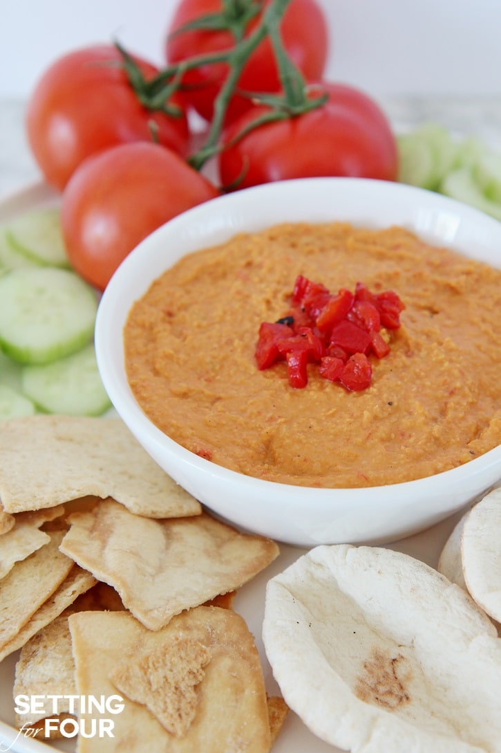 Roasted Red Pepper Hummus with Sun-Dried Tomatoes: Bored with your every day snack routine? Mix it up with the NEW BUSH'S® Hummus Made Easy in a pouch - a homemade, creamy hummus recipe that you can whip up in just three simple steps! Just 5 minutes to prepare. You'll love this easy vegetarian recipe - makes a quick and delicious party dip and spread. Get the recipe at Setting for Four.