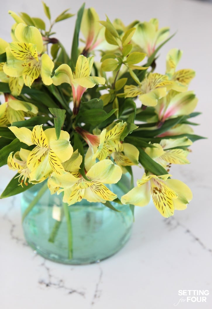 A gorgeous floral centerpiece using a DIY vase tinted sea-glass green is perfect for weddings, parties, showers and your dining table at home!