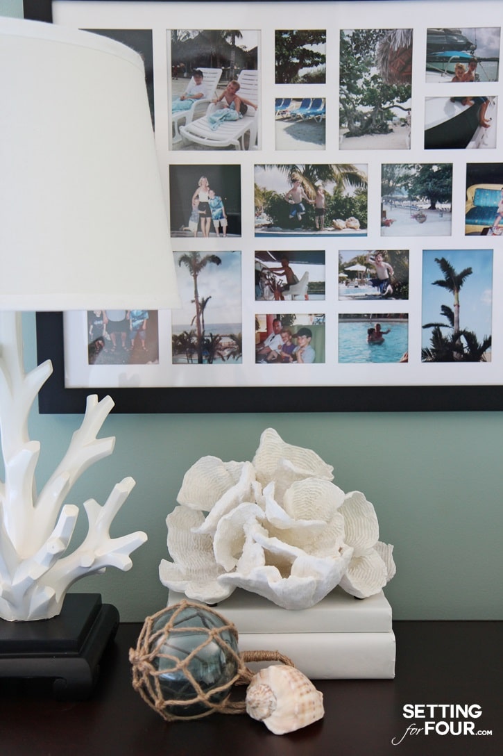 Dresser vignette with shells, table lamp and family photos