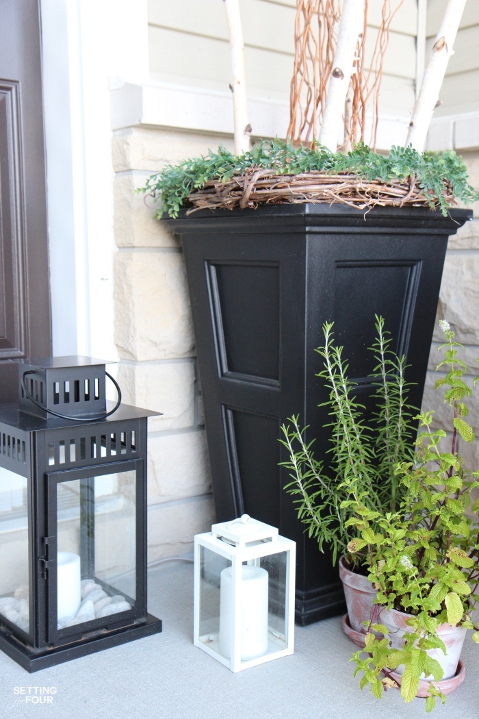 Outdoor front porch urns filled with curly willow and birch branches give this porch huge impact and curb appeal!