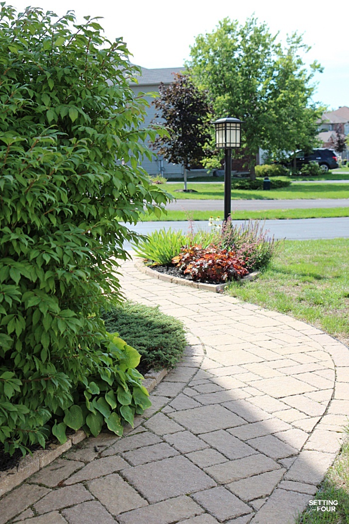 Inlaid stone brick path that runs along the front of our home - what a beautiful landscape design.