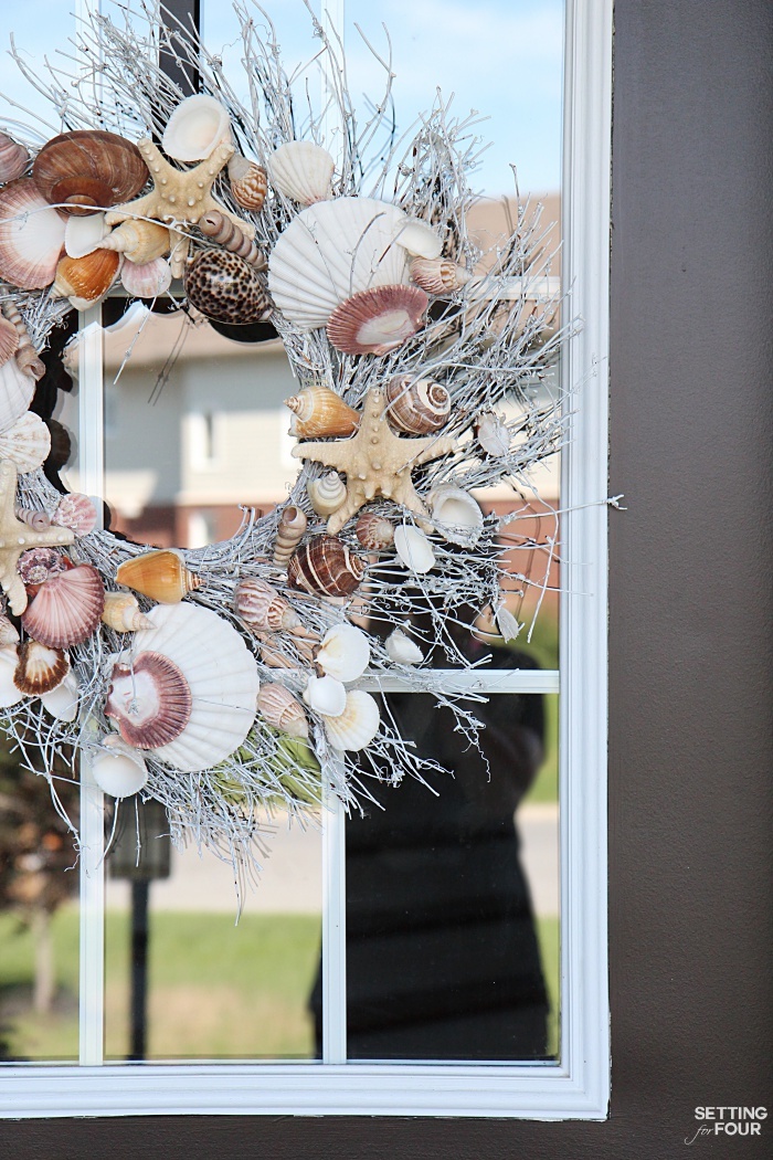 A shell wreath with beautiful starfish, shells and white twigs makes a big statement for any porch!