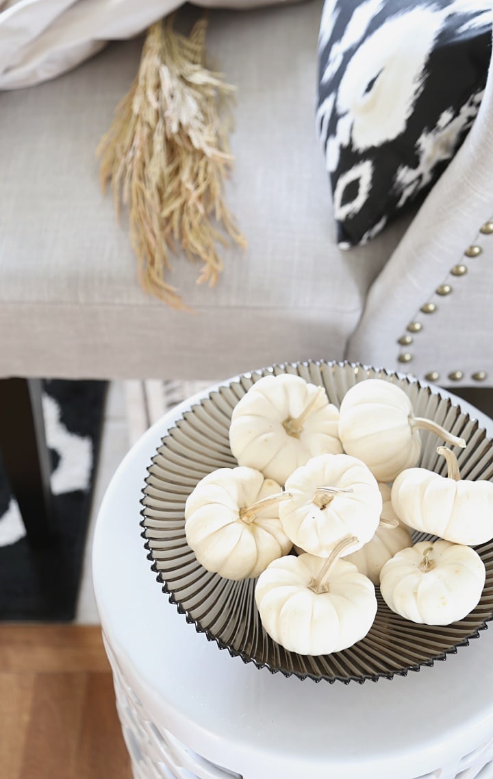 Baby boo pumpkin fall bowl filler: See this easy fall decorating idea and more in this design blogger's GLAM neutral fall home tour!