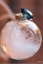 15 Minute is all it takes to make these pretty DIY Jewel and Feather Ball Ornament! Hang on your tree or use as a present or gift bag topper! Great handmade Christmas craft and gift idea.