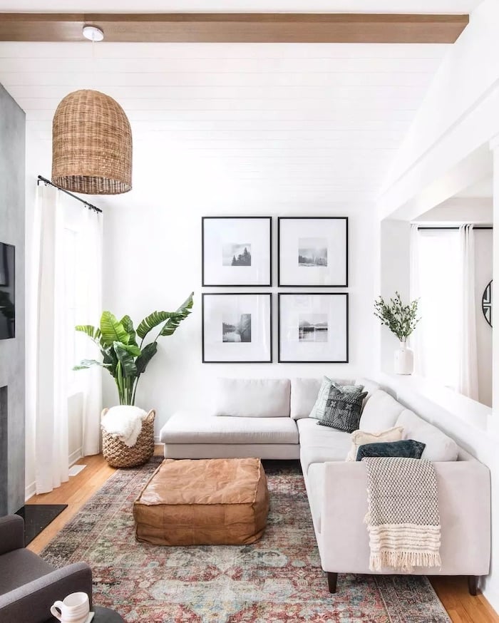 How To Make A Small Living Room Feel Bigger!, low profile chaise sofa and ottoman with a pendant light, light colored white walls, black and white photography art, thin ceiling beam, small living room furniture arrangement idea, modern, minimalist, transitional home ideas, 2025 trends