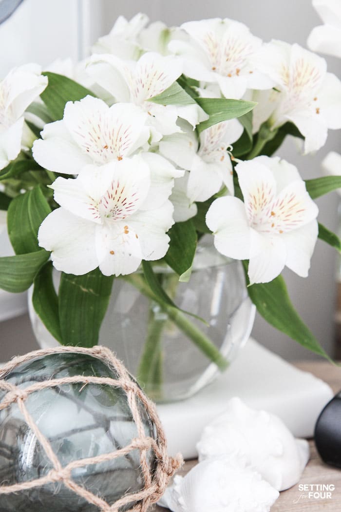 See the 12 ways to create a COZY guest bedroom your company will LOVE! : Add a beautiful vase of flowers for the night table.