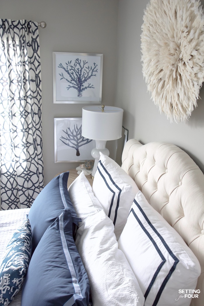 See my new guest bedroom updates including a gorgeous white juju hat that I hung above the bed, new navy blue duvet cover with matching shams and new column table lamps!  Decorating this room has been so much fun!