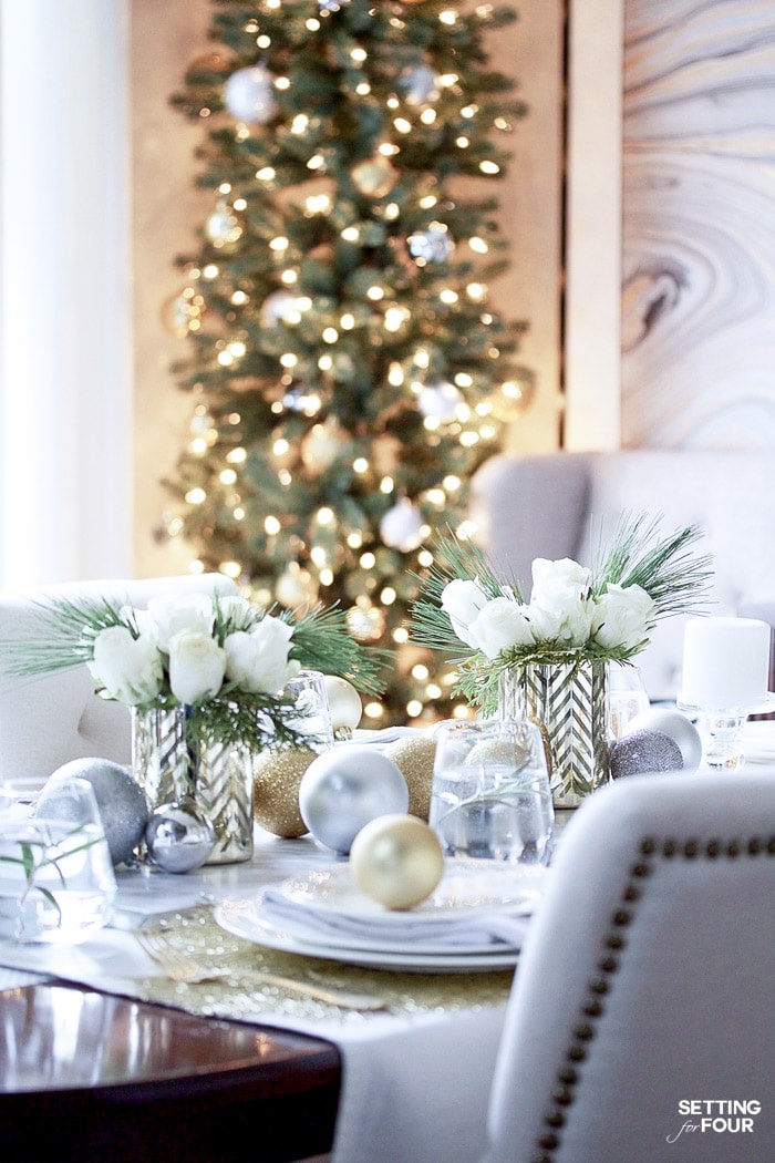 Learn how to create this beautiful Gold and White Glam Christmas tablescape including these rose and pine winter floral arrangements!