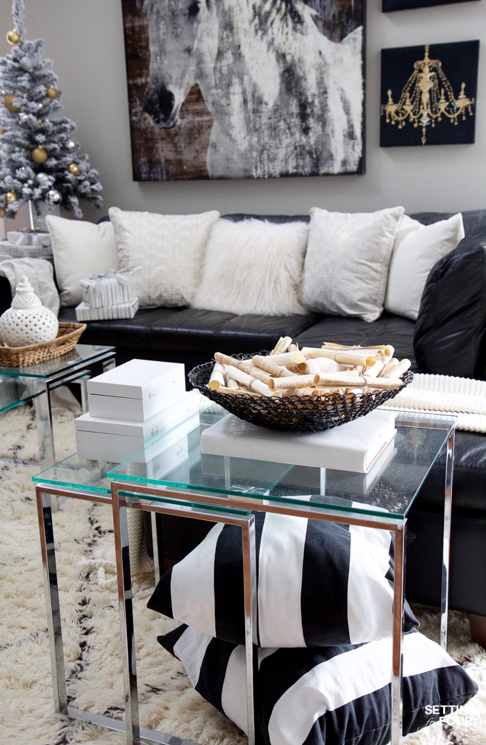 See my Glam Black, White and Gold Family Room Decor Ideas! I kept my holiday decor simple this year - a mini flocked Christmas tree with gold and silver ornaments, some faux pine greenery and bowls of metallic Christmas balls keep this space looking light and bright but festive too! See my entire family room here! Leather sectional sofa, poufs, shag area rug, crystal table lamps, chunky knit throw blanket, black and white color palette, faux fur pillows, metallic wall art.