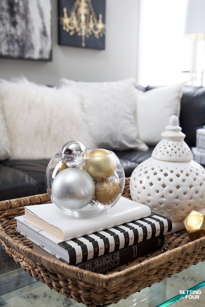 See my Glam Black, White and Gold Family Room Decor Ideas! I kept my holiday decor simple this year - a mini flocked Christmas tree with gold and silver ornaments, some faux pine greenery and bowls of metallic Christmas balls keep this space looking light and bright but festive too! See my entire family room here! Leather sectional sofa, poufs, shag area rug, crystal table lamps, chunky knit throw blanket, black and white color palette, faux fur pillows, metallic wall art.