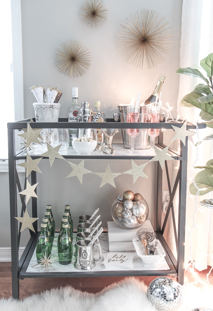 Bar Carts and New Year's Eve Parties go hand in hand! Learn how to create a fun New Years Eve Bar Cart with festive party supplies, delicious food and bubbly drinks! Celebrate the New Year in style!