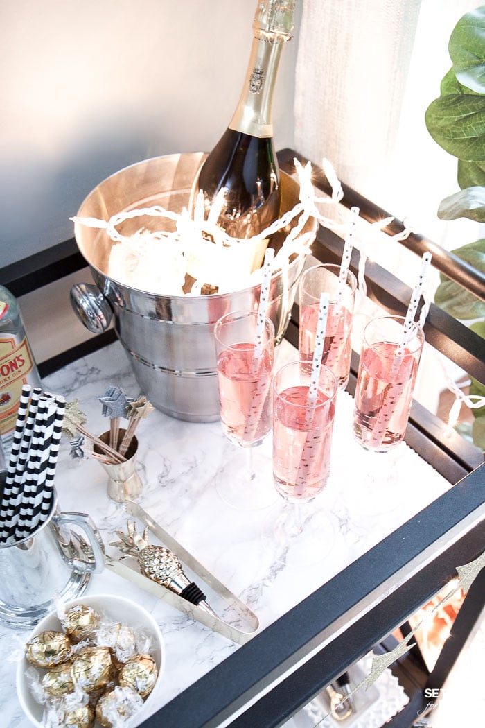 Bar Carts and New Year's Eve Parties go hand in hand! Learn how to create a fun New Years Eve Bar Cart with festive party supplies, delicious food and bubbly drinks! Celebrate the New Year in style!