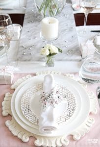 Blush Pink Valentines Day Table Decorations: Want to decorate your table for Valentine's Day but not sure where to start or you want to try something new? Take a look at this lovely Blush Pink Valentine’s Day Table Decor! Read this step by step diy decor lesson - you’ll learn how to set and decorate a lovely blush pink table for a dinner party or party of two, so you can copy it in your home! Celebrate Valentine’s Day with these lovely entertaining tips including ideas for dish ware, flatware, glassware, a pretty rose centerpiece idea, and fun Valentines Day take-home gift ideas for your guests! These table decor ideas would also be perfect for a Valentine's Day wedding reception or bridal shower!