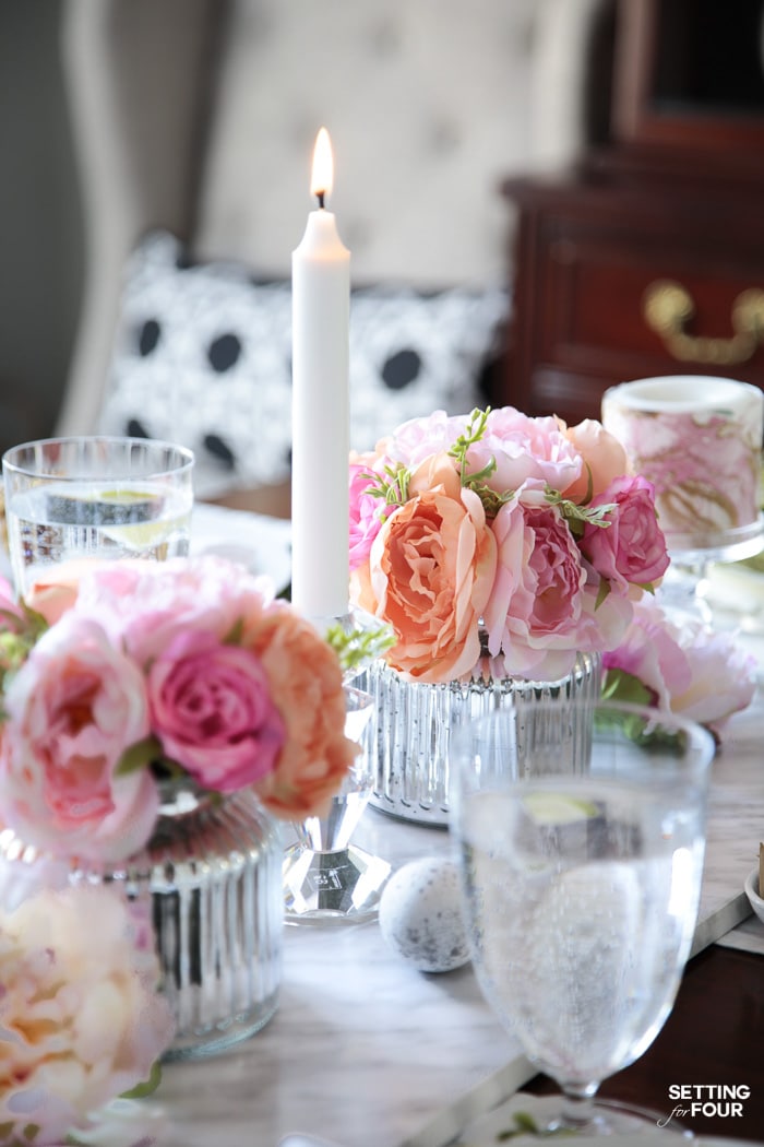 Tablescape with candlelight and silk flower centerpieces.