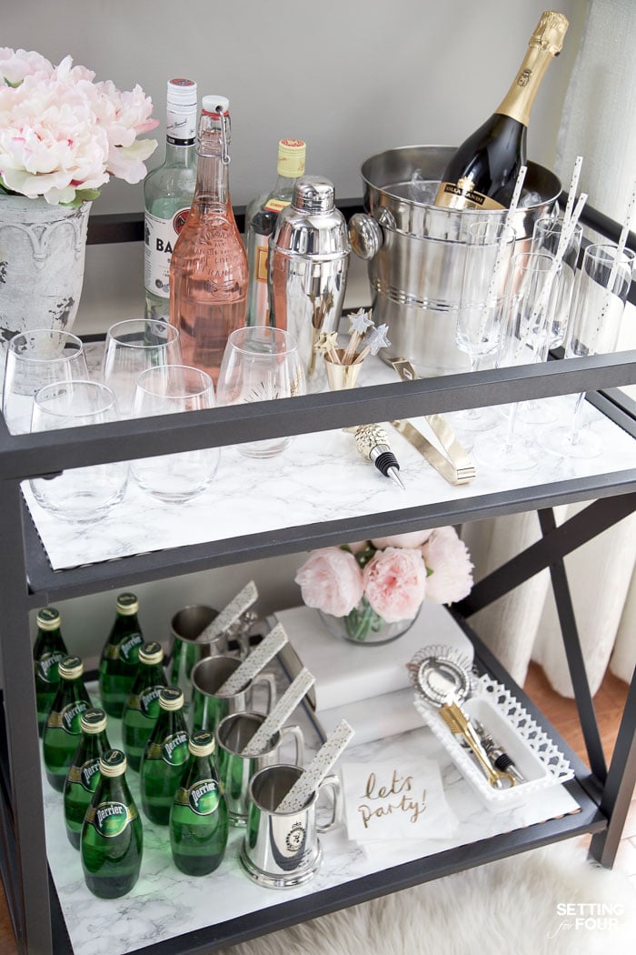 See this quick and easy DIY marble bar cart top and shelf tutorial to give your bar cart the look and elegance of real marble! Marble bar carts are so gorgeous but are SO expensive! Get the look of Carrara marble for less with this easy marble DIY project!