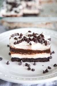 This Easy Chocolate Lasagna No Bake Dessert is so quick to make! It's a decadent, one dish dessert that's perfect for potlucks and dinner parties. I've added chocolate liqueur to the recipe for an extra chocolatey flavor - but you can omit that if you like! A great make ahead recipe that can be frozen too. Everyone will be asking you for this recipe! #chocolate #cheesecake #nobake #potluck #party #entertaining