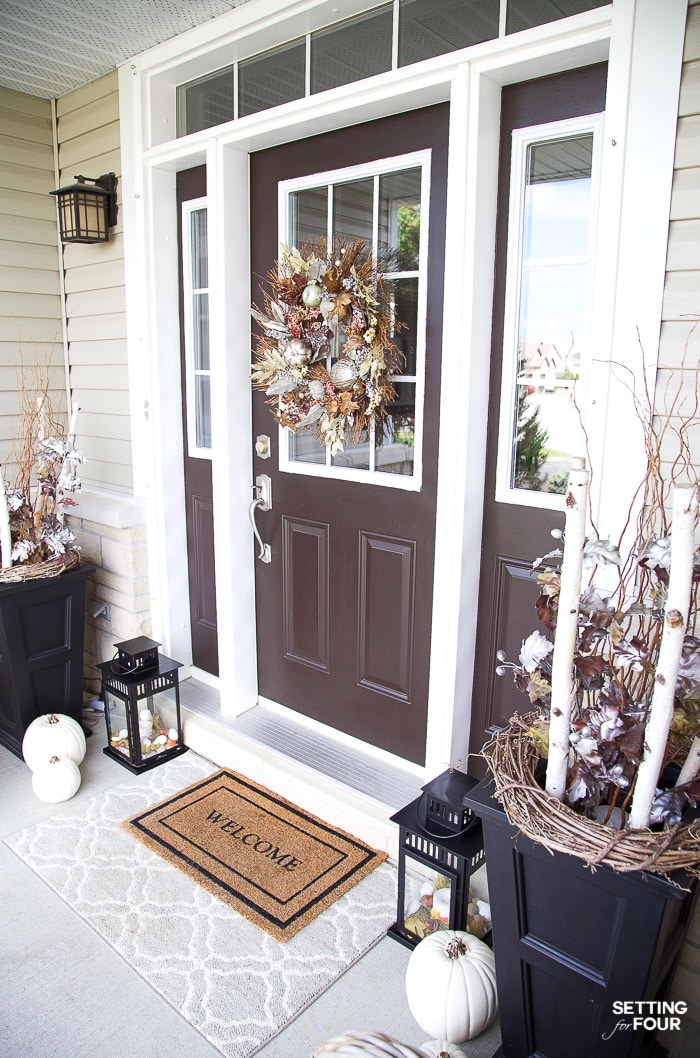 Fall porch with wreath on front door and fall pots.