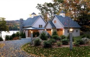 Beautiful fall home exterior with stone exterior and driveway curb appeal