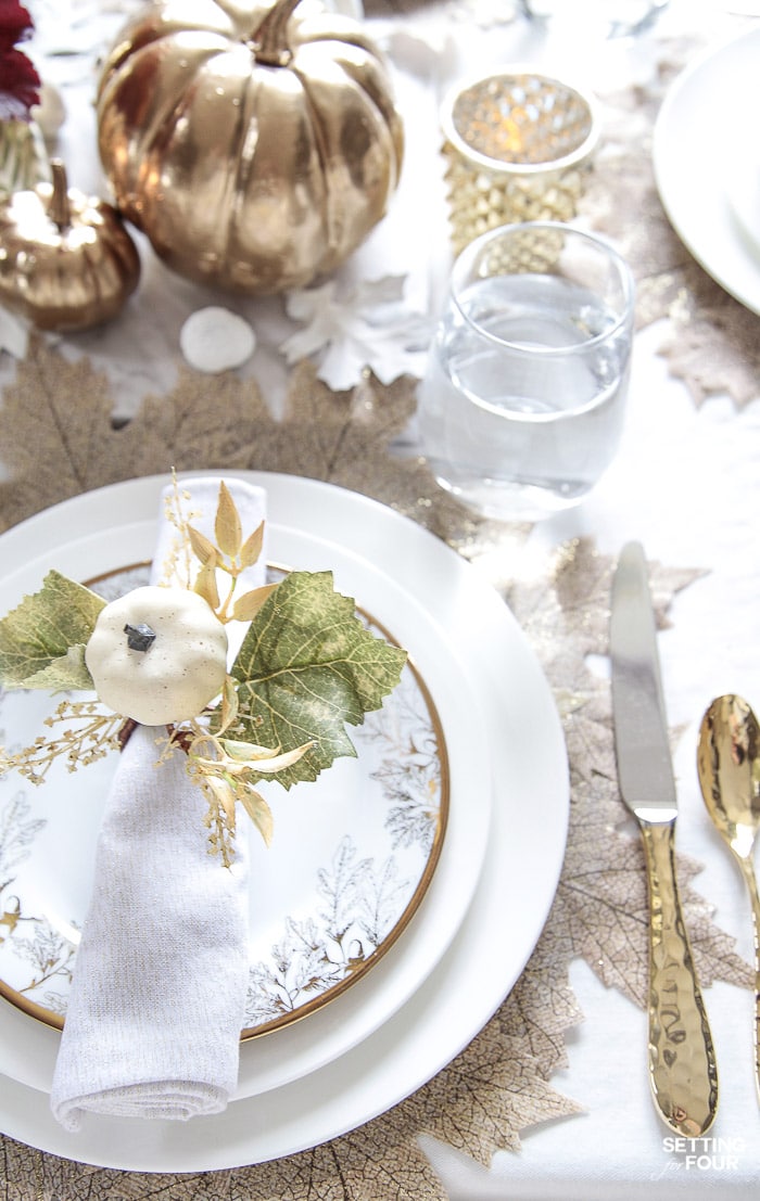 Gold flatware and white dishes decorated for fall. #white #dishes #dinnerware #gold #flatware #leaf #placemats #pumpkins