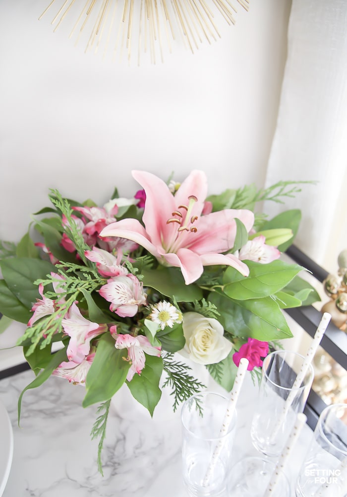 How to make this quick and easy Christmas flower arrangement! #diy #flowers #floral #christmas #arrangement #pink #greenery #centerpiece