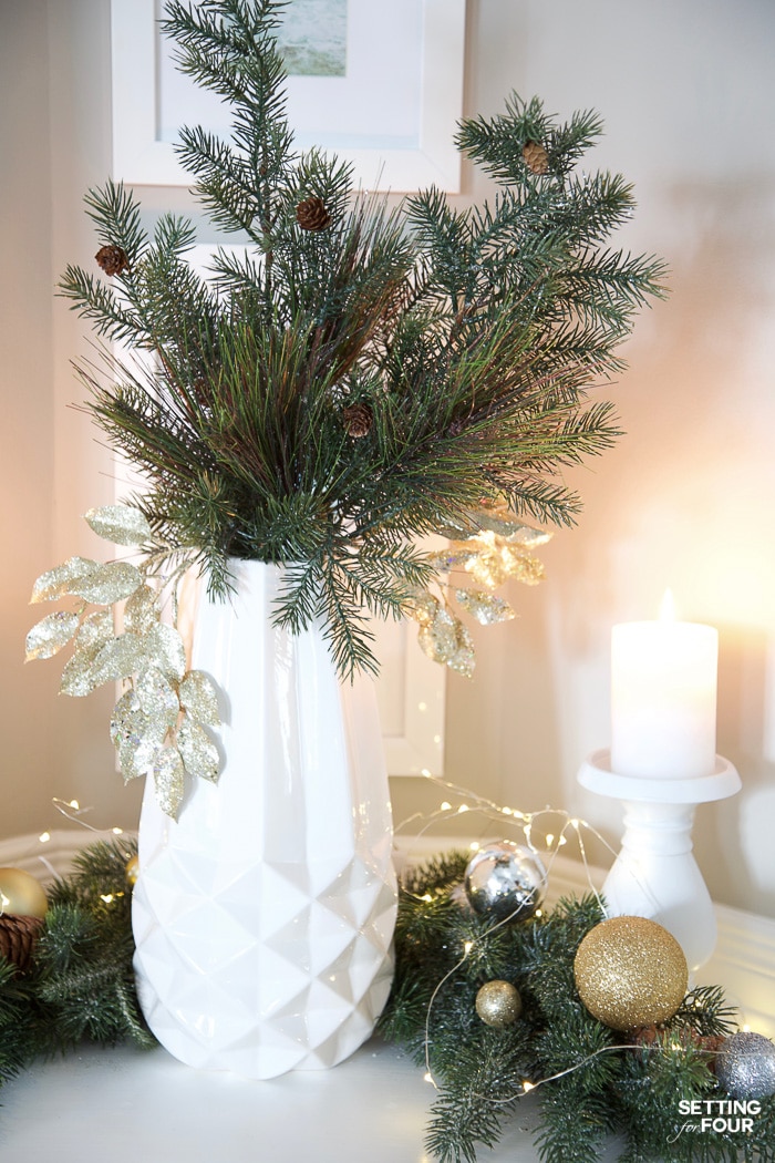 Wall Niche Christmas Decor With Garland, Fairy Lights and Greenery #fairylights #christmaslights #wallniche #decorideas #arrangement #christmasgreenery #christmasgarland #candlelight