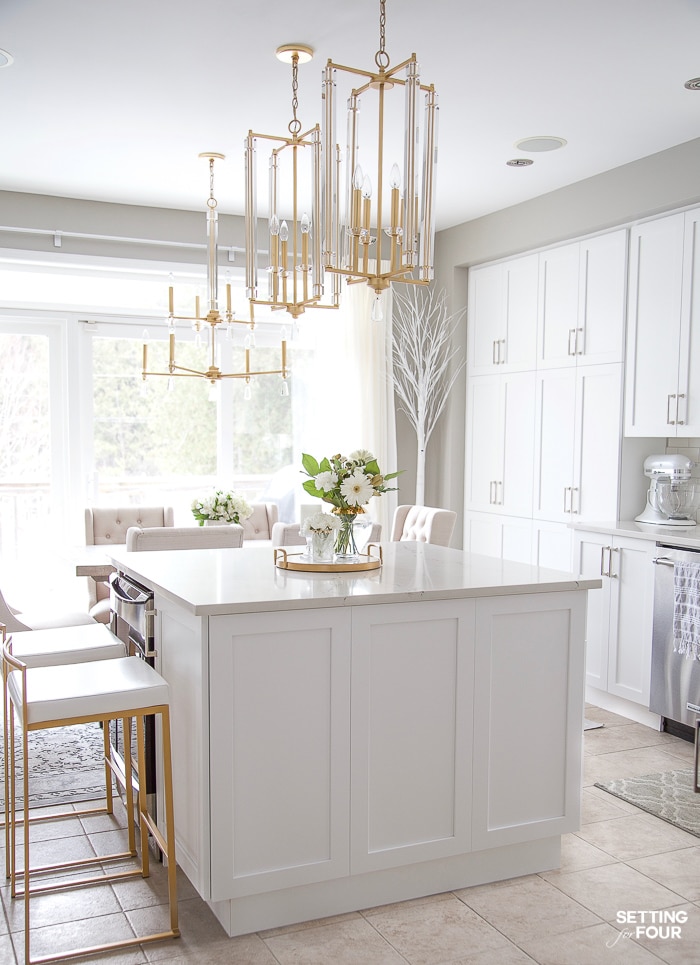 Kitchen remodel ideas. Before and after pictures with details on new white cabinets, lighting and Caesarstone quartz countertops. #kitchen #renovation #white #cabinets #caesarstone #quartz #countertop #subway #tile #backsplash