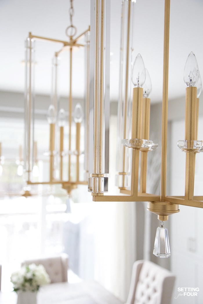 Elegant gold and crystal kitchen pendant lights over kitchen island in a white kitchen. Modern traditional style. Gold and crystal. #white #kitchen #island #lighting #pendants #gold #crystal 