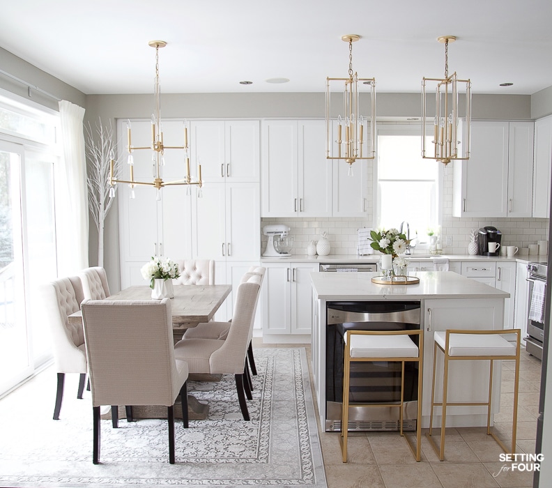 Gray and white kitchen layout after remodeling. Eat in kitchen with dining table, kitchen lighting over the table, pendants over the island. Modern mixed with traditional style. #kitchen #white #simple #transitional #traditional #glam #bulkheads