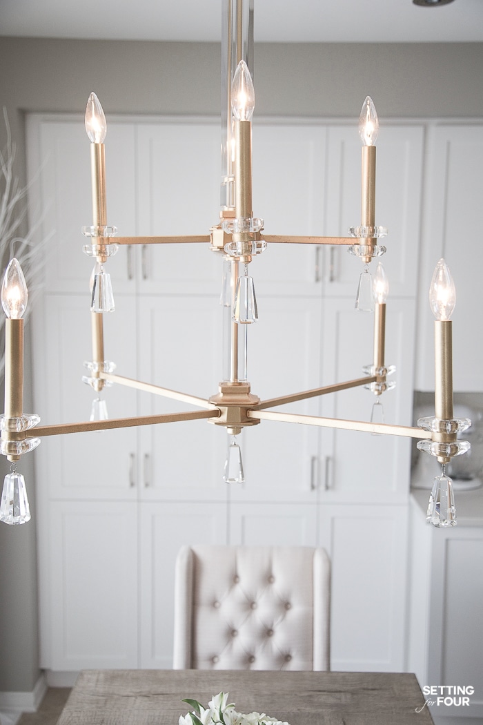 Elegant gold and crystal kitchen chandelier light over eat in kitchen dining table in a transitional white kitchen. Glam. Gold and crystal. #white #eatin #kitchen #lighting #chandelier #gold #crystal 