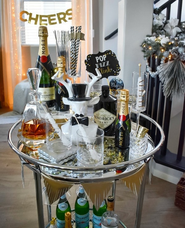 Round bar cart used as a drink station for New Year's Eve. #drinkstation #partydecor #newyearseve #barcart