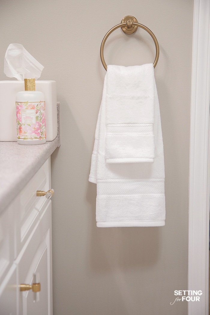 Layer hand towels on a towel ring to decorate a bathroom. #towelring #brass #bathroom #towel #storage #decorate